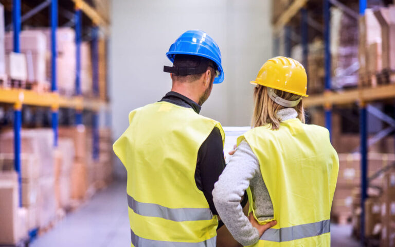 young warehouse workers working together d